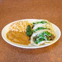 Taco Dinner · 3 tacos, with rice and beans. Please specify which meat choice you would like.