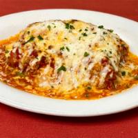 Lasagna Rustica · Homemade pasta stuffed with homemade pork and beef sauce, hardboiled eggs, ham, mozzarella &...