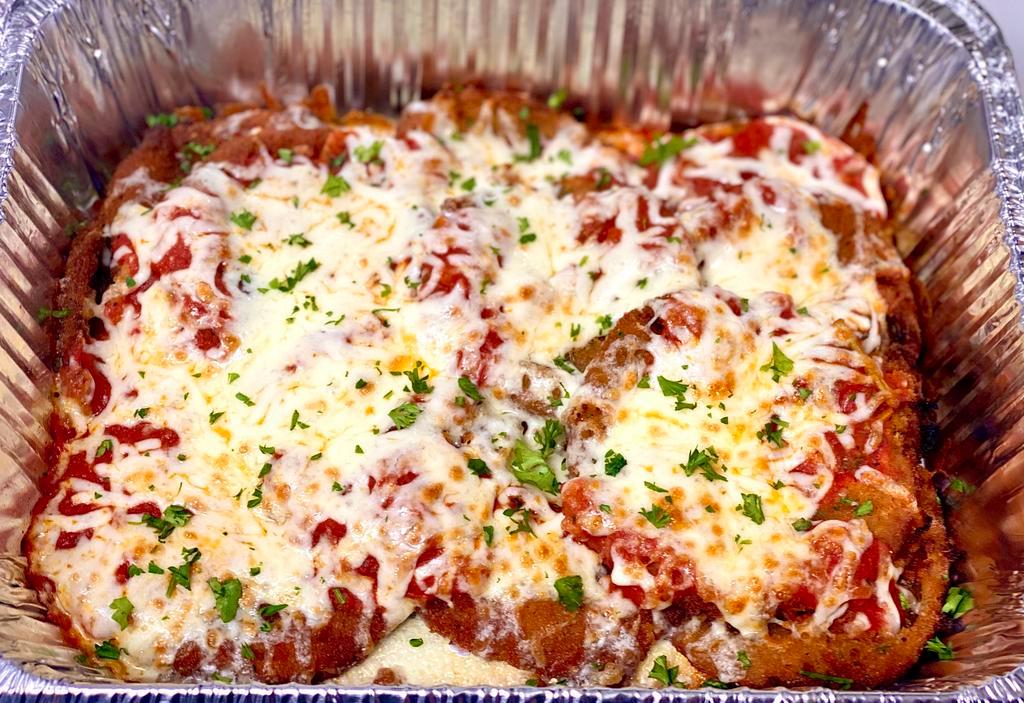 Eggplant Parmigiana Family Style · Hand-breaded eggplant fried and topped with mozzarella cheese and our homemade red sauce, served over penne pasta with a garden salad & bread; serves 4-5 people
