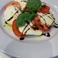 Caprese Salad · Organic Roma Tomatoes, Fresh Mozzarella, and Basil drizzled with a Sweet Balsamic Reduction ...
