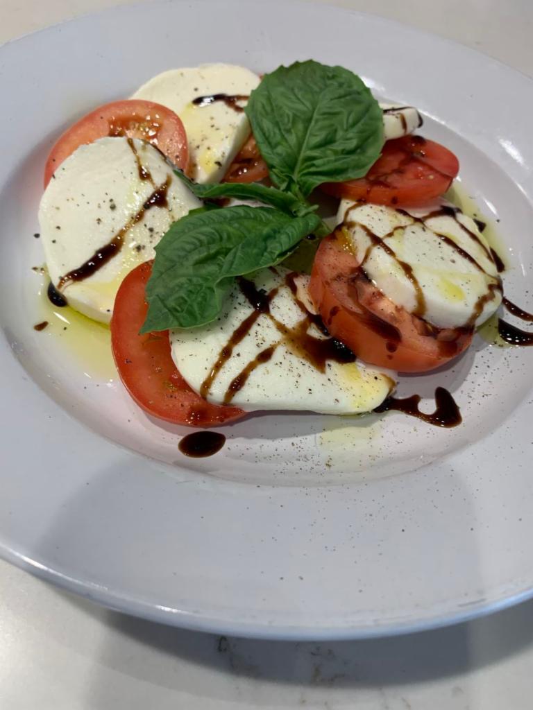 Caprese Salad · Organic Roma Tomatoes, Fresh Mozzarella, and Basil drizzled with a Sweet Balsamic Reduction &
Extra Virgin Olive Oil