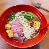 Spicy Hot Pot Noodle Soup · Spicy noodle soup with bok choy, beef brisket, tofu, half boiled egg, cilantro and green sca...