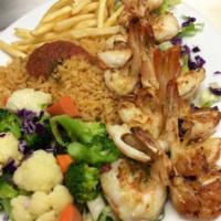 Camarones a la Plancha · Grilled shrimp in a butter sauce, served with rice, veggies and french fries.