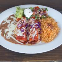 Enchiladas de Camaron · 2 shrimp enchiladas topped with red sauce, served with rice and beans. Garnished with guacam...