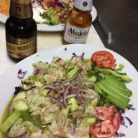 Camarones Aguachiles · Citrus cooked shrimp served with red onion, sliced cucumber and avocados in a spicy green sa...