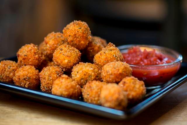 Mozzarella Bites · Fried bite-sized pieces of mozzarella cheese with a panko breading. Served with marinara for dipping.