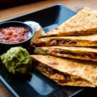 6. Quesadilla · Tomato-basil tortilla loaded with pepper jack cheese, red beans, diced bell peppers and choi...