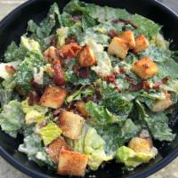 12. Caesar Salad · Romaine lettuce, chopped tomatoes and croutons in a creamy Caesar dressing, topped with Parm...