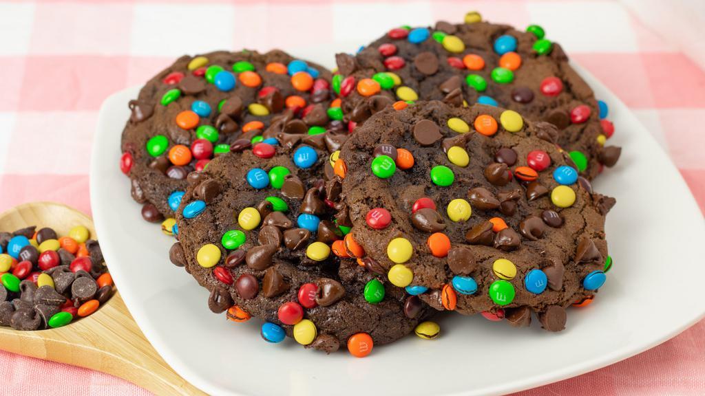  Giant Double Chocolate Chip M&M Cookies · Lots of chocolate and rainbow-colored candy? My kiddos must've thought this one up! 
Best enjoyed with a cold glass of milk, double chocolate M&M cookies are sure to bring out your inner child!