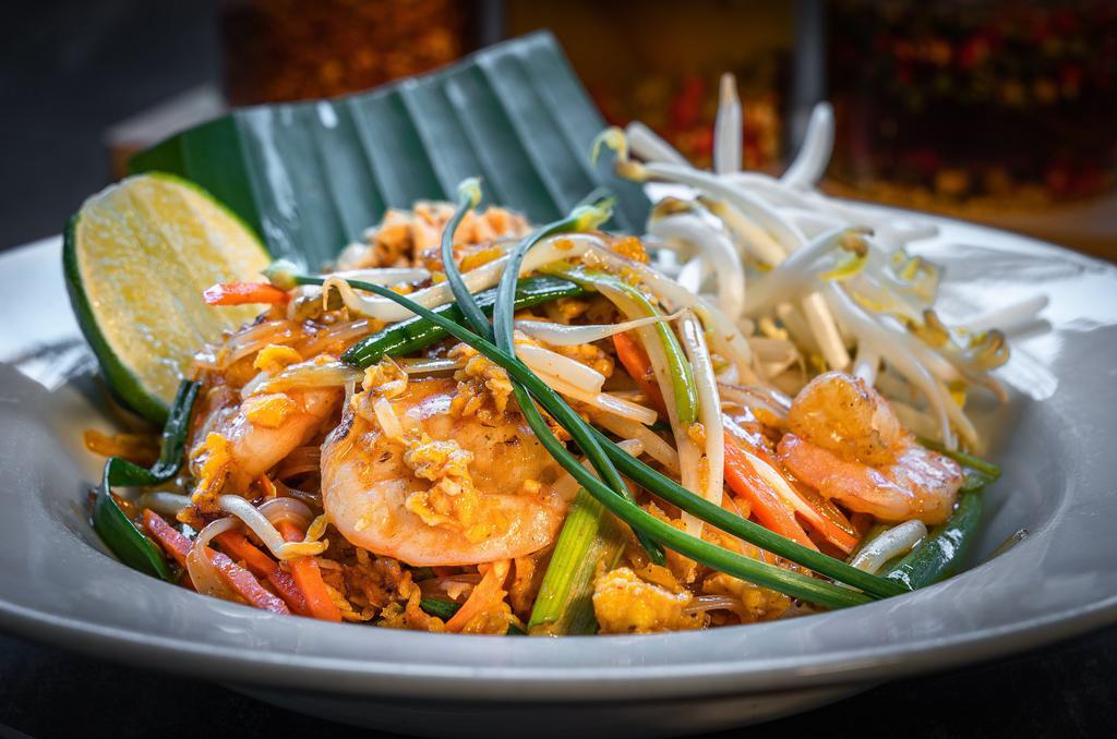 Pad Thai · Stir fried rice noodle with sweet tamarind sauce, bean sprouts, green onions, carrots. Served with a side of peanuts and lime.