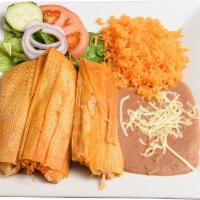 Lunch Tamal · 2 homemade pork or chicken tamale steamed to perfection, server with spanish rice and beans.