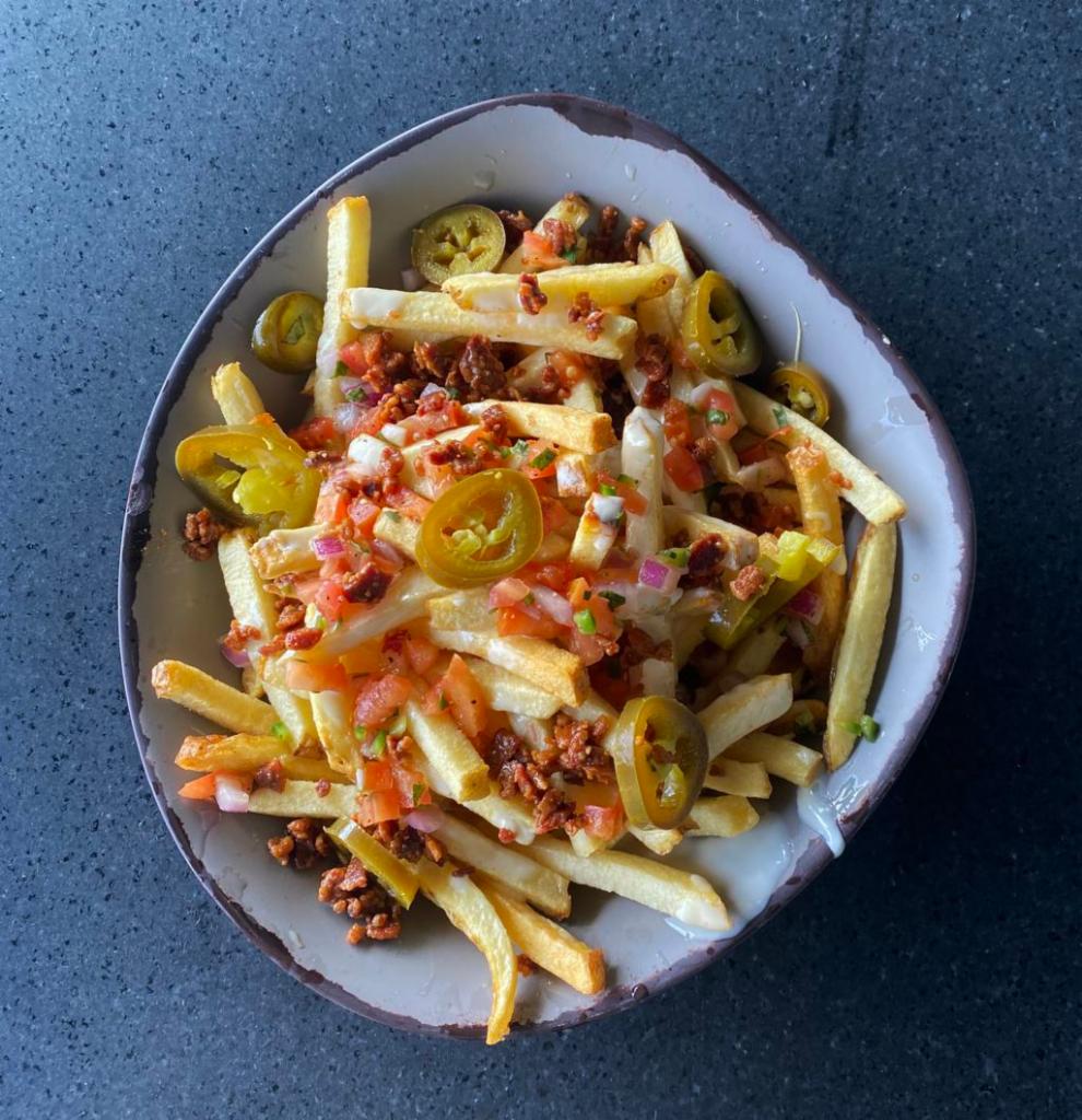Loaded Hand-Cut Cheese Fries · Hand-cut golden french fries topped with homemade queso, smoky bacon, jalapenos & pico de gallo