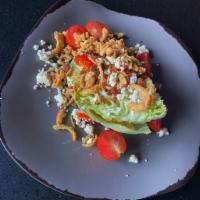 Iceberg Wedge Salad · Fresh iceberg lettuce wedge, topped with smoky bacon, red cherry tomatoes, blue cheese crumb...