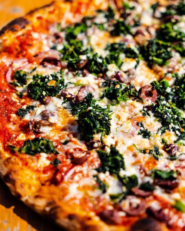 Mediterranean Pizza · Red onion, Kalamata olive, sauteed spinach, feta and mozzarella cheeses, house tomato sauce and fresh dill.
