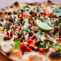 Vegan Soyrizo Pizza · Garlic oil, pickled onions, tomatoes, peppadews, corn sliced jalapenos and soyrizo, topped w...