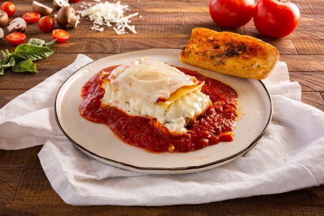 Meat Lasagna · Layered lasagna noodles with seasoned grounded beef with ricotta and mozzarella.