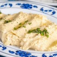 Hummus · Creamy homemade hummus served with luxurious tahini, garnished with paprika oil finished wit...