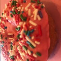 White Cake Donut with Pink Icing and Rainbow Sprinkle · 