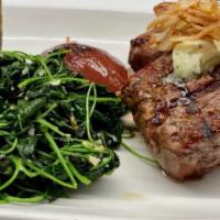 New York Strip Steak · Gorgonzola potato gratin, spinach, and mushrooms, roasted garlic-herb butter, crispy onions.