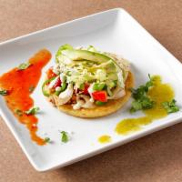 Sopes · A circle of fried corn masa topped with refried beans, crumbled cheese, lettuce, avocado and...