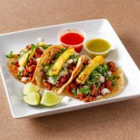 Al Pastor Taco · Pork marinated with a blend of different chili peppers, spices and herbs.