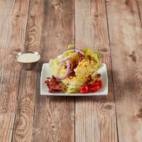 Iceberg Wedge Salad · Served with onion, tomato and crisp bacon.