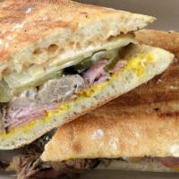 The Cuban · Heritage pork, smoked ham, bread and butter pickles, swiss cheese, mustard, and chipotle aio...