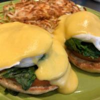 Traditional Eggs Benedict · Poached eggs and Canadian bacon on an English muffin topped with Hollandaise sauce. 