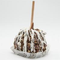 Pecan Bear Caramel Apple · A Granny Smith apple covered in fresh caramel then rolled in chopped pecans, drizzled in mil...