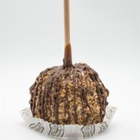 Snickers Caramel Apple · A Granny Smith apple covered in fresh caramel, rolled in tiger butter (a mixture of peanut b...