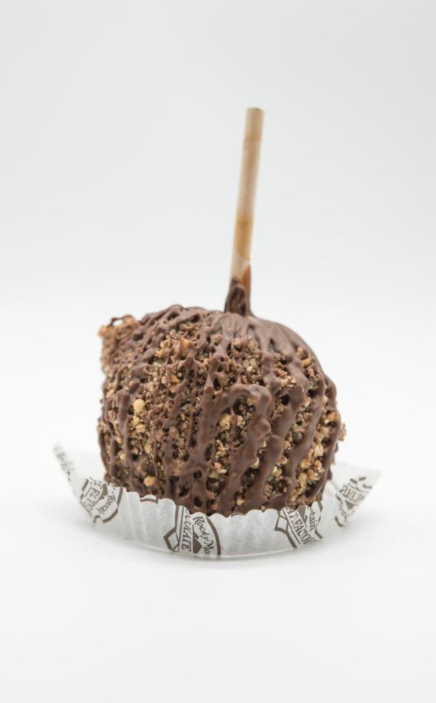 English Toffee Caramel Apple · A Granny Smith apple covered in fresh caramel, rolled in crushed toffee drizzled with milk chocolate.