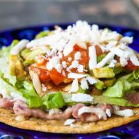 Tostadas · Refried beans, lettuce, tomatoes, sour cream and cheese.