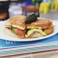 Torta · A toasted bolillo filled with refried beans, cheese, onions, avocado, tomatoes chipotle sauc...