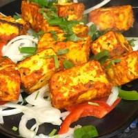 Paneer Tikka, Gluten free.  · Paneer chunks are marinated in spiced yogurt, then grilled over a charcoal flame.