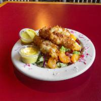 Coconut Chicken Salad · Mixed greens topped with Mandarin oranges, sun-dried tomatoes, coconut battered chicken, and...