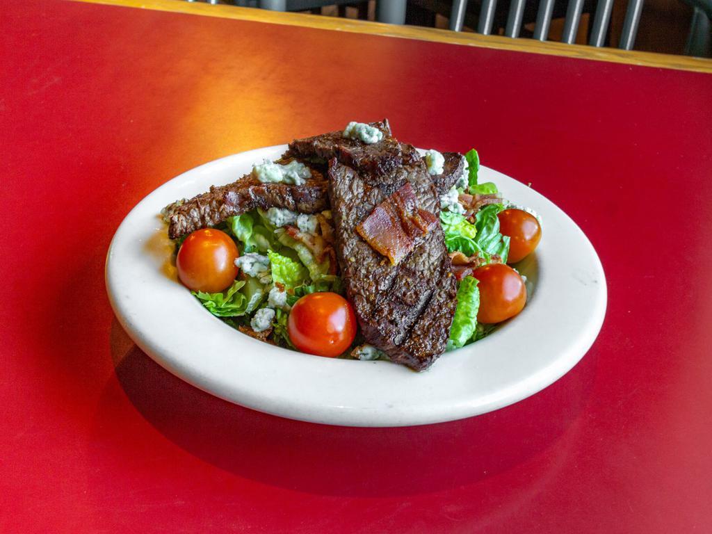 Black and Bleu Steak Salad · Sliced sirloin, mixed greens, tomatoes, bacon, and bleu cheese crumbles. Add avocado for an additional charge.