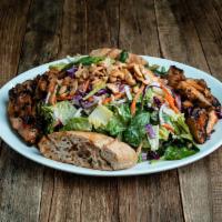 Sesame Ginger Chicken Salad · Grilled sweet chili-glazed chicken, carrots, red onion, cabbage, and cashews.
