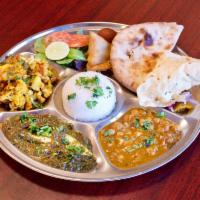 Saran Thali · 3 special curries, samosa and tikki as appetizer, lentil soup, salad, raita, white rice, cho...