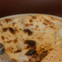 Tandoori Naan · Unleavened, light and freshly baked to the order in our clay oven.