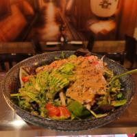 Tuna Tataki Salad · Sliced seared tuna on top with spring mix, lettuce, cucumber, carrots, raisins, tomato, radi...