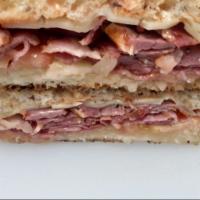 Pastrami Melt · Swiss cheese, mustard. Served on sourdough with fruit, macaroni, or potato salad.