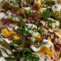 Texas Cheese Fries · Cheddar Jack Cheese, Bacon, Jalapenos, and Ranch Dressing. Try it with Chicken!