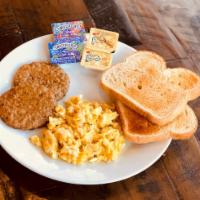 Toast with Eggs and Sausage · A bread toast with scrambled eggs and 2 sausages! Served with butter and jam on the side.