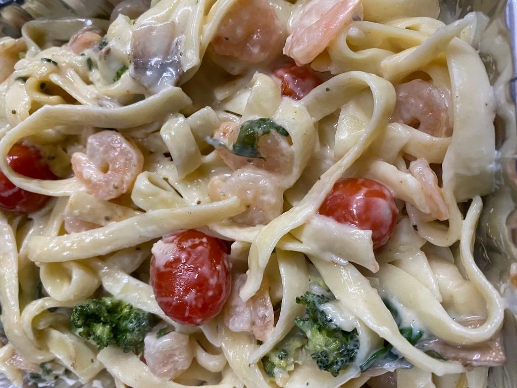 Shrimp Fettuccine Alfredo Pasta · Spinach, cherry tomatoes, shrimp in our old bay spicy alfredo sauce and topped with shredded Parmesan cheese and fresh cut green onion.