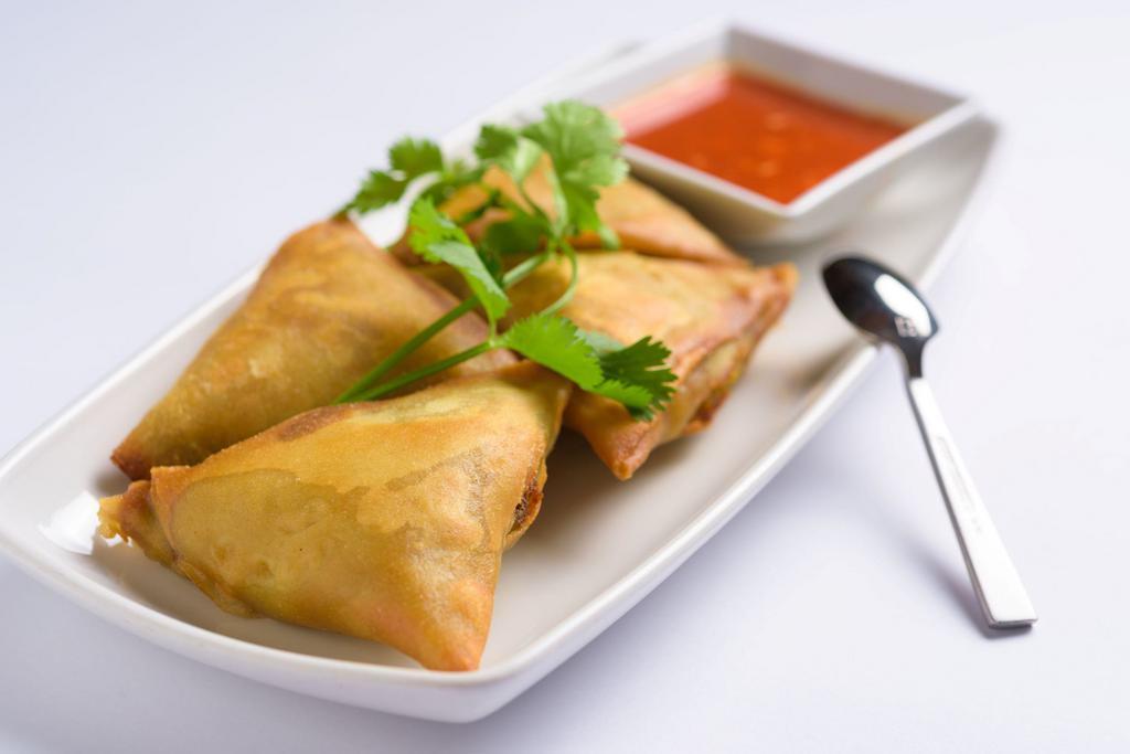 Samosas · Vegetarian. Flour turnover filled with potatoes, red onions, peas, carrots, and a blend of unique spices served with special house sauce.