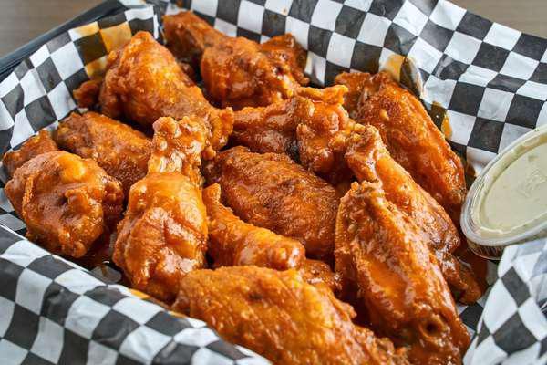 50 Pieces Bone-In Wings · Bone-in wings, with choice of 2 flavors. Served with ranch. Carrot sticks are available upon request.