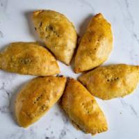 Meat Pie · Baked dough filled with minced beef, carrot, and potato.