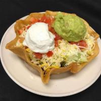 Bobbys Fiesta Taco Salad · A bed of lettuce in a large flour tortilla shell topped with your choice of meat, tomatoes, ...