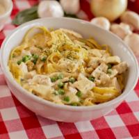 Homemade Fettuccine Alfredo · Homemade fettuccine served in a light cream sauce topped with Parmesan and parsley.
