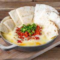 Queso Fundido con Chorizo  · (Melted cheese, with shredded chorizo and arepa chips)